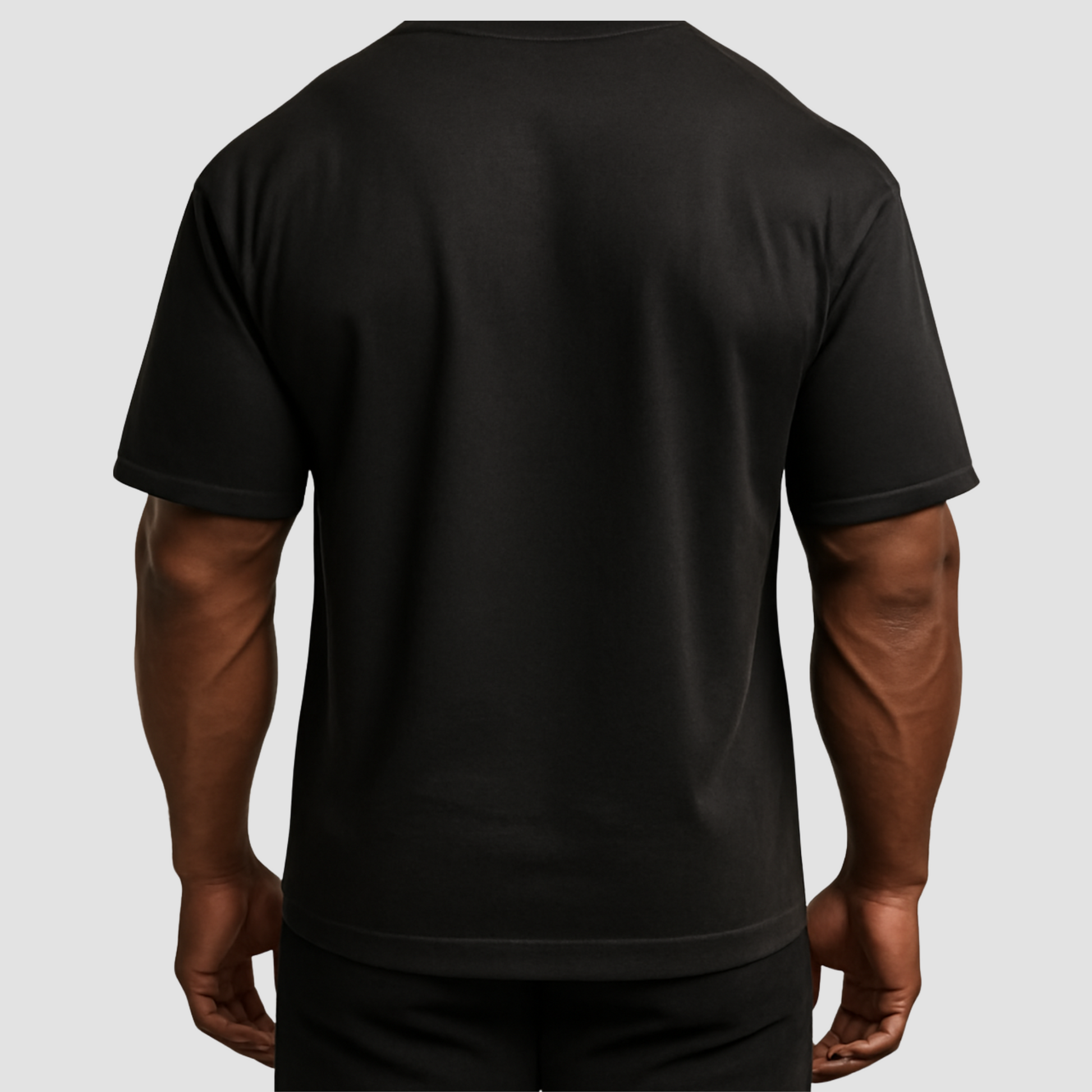 Back view men’s oversized black cotton gym t-shirt with relaxed fit, soft fabric, everyday wear.